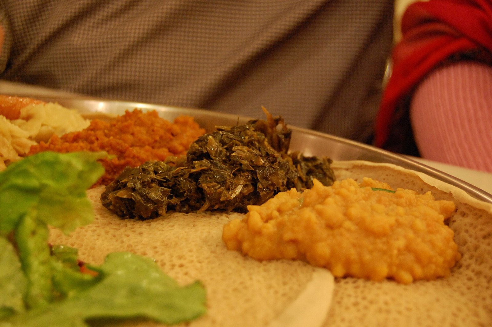 Kik alicha, misir wot and gomen: split peas, lentils and greens on injera